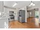Open kitchen featuring stainless steel appliances and adjacent eating area with hardwood floors at 1333 Laura Ln, Austell, GA 30168