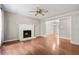Bright living room featuring hardwood floors, a fireplace, and a ceiling fan at 1333 Laura Ln, Austell, GA 30168