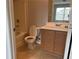A bathroom with neutral tones, a vanity with storage, and a toilet features functional design at 17301 Waldrop Cv, Decatur, GA 30034
