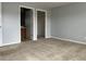 A spacious bedroom with neutral carpet and two doors for closet and bathroom access at 17301 Waldrop Cv, Decatur, GA 30034
