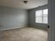 Neutral carpet and a window with blinds brighten this bedroom at 17301 Waldrop Cv, Decatur, GA 30034