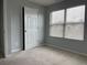 Well-lit bedroom featuring neutral walls, carpet, and a large window at 17301 Waldrop Cv, Decatur, GA 30034