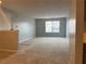 View of the living room, showcasing natural light, neutral paint and carpeted floors at 17301 Waldrop Cv, Decatur, GA 30034