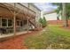 Multi-level backyard with a stone patio, upper deck, stairs, and green lawn at 2585 Drew Valley Ne Rd, Brookhaven, GA 30319