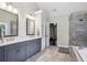 Bathroom with double vanity, marble countertops, shower and soaking tub at 2585 Drew Valley Ne Rd, Brookhaven, GA 30319