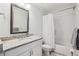 Fresh bathroom offering a single granite vanity with a shower-tub combo and white subway tiling at 2585 Drew Valley Ne Rd, Brookhaven, GA 30319