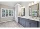 Bathroom with double vanity, marble countertops, and shuttered windows at 2585 Drew Valley Ne Rd, Brookhaven, GA 30319