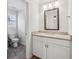 Bathroom featuring a granite vanity, decorative mirror, and tiled flooring with a separate toilet room at 2585 Drew Valley Ne Rd, Brookhaven, GA 30319