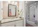 Bright bathroom featuring a marble countertop vanity and shower-tub combination with white subway tile at 2585 Drew Valley Ne Rd, Brookhaven, GA 30319