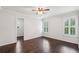 Bright bedroom showcasing dark hardwood floors, fresh white walls, shuttered windows, and a ceiling fan at 2585 Drew Valley Ne Rd, Brookhaven, GA 30319