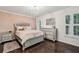 Cozy bedroom featuring a silver bed frame, wood floors, and natural light at 2585 Drew Valley Ne Rd, Brookhaven, GA 30319
