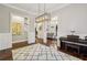 A home office with a piano, wainscoting, a modern light fixture, and natural light from a large window at 2585 Drew Valley Ne Rd, Brookhaven, GA 30319