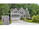 Beautiful two-story home featuring a two-car garage, gray siding, and professionally landscaped front yard at 2585 Drew Valley Ne Rd, Brookhaven, GA 30319