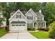 Charming two-story home with a well-manicured lawn, two-car garage, and covered front porch at 2585 Drew Valley Ne Rd, Brookhaven, GA 30319