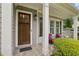 Cozy front porch with stone flooring and comfortable seating, perfect for enjoying the outdoors at 2585 Drew Valley Ne Rd, Brookhaven, GA 30319