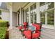 Inviting front porch featuring stone flooring, white columns, and comfortable seating with accent pillows at 2585 Drew Valley Ne Rd, Brookhaven, GA 30319