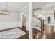 Hallway featuring hardwood floors, wainscoting, staircase, and elegant lighting fixtures at 2585 Drew Valley Ne Rd, Brookhaven, GA 30319