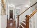 Elegant hallway with hardwood floors, a staircase, and sophisticated decor leading to various rooms at 2585 Drew Valley Ne Rd, Brookhaven, GA 30319