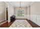 A home office with a piano, wainscoting, a modern light fixture, and natural light from a large window at 2585 Drew Valley Ne Rd, Brookhaven, GA 30319