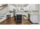 Modern kitchen featuring white cabinets, stainless steel appliances, and a gray island with bar seating at 2585 Drew Valley Ne Rd, Brookhaven, GA 30319