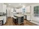 Bright kitchen features white cabinets, stainless steel appliances, an island, and access to the deck at 2585 Drew Valley Ne Rd, Brookhaven, GA 30319