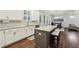 Open kitchen with stainless steel appliances, granite counters, island with seating, and hardwood floors at 2585 Drew Valley Ne Rd, Brookhaven, GA 30319