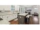 Bright open kitchen features granite counters, white cabinets, stainless appliances, island, and hardwood flooring at 2585 Drew Valley Ne Rd, Brookhaven, GA 30319