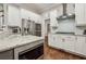 Modern kitchen with stainless appliances, granite countertops, island, and white cabinets at 2585 Drew Valley Ne Rd, Brookhaven, GA 30319