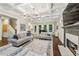 Open-concept living room with a fireplace, hardwood floors, and seamless transitions to the dining area and kitchen at 2585 Drew Valley Ne Rd, Brookhaven, GA 30319