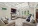 Bright living room featuring coffered ceilings, a fireplace, hardwood floors, and large windows at 2585 Drew Valley Ne Rd, Brookhaven, GA 30319