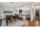 Open-concept living and dining area featuring hardwood floors, coffered ceilings, and abundant natural light at 2585 Drew Valley Ne Rd, Brookhaven, GA 30319