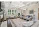 A well-lit living room featuring a coffered ceiling, fireplace, neutral-toned furniture, and a large window at 2585 Drew Valley Ne Rd, Brookhaven, GA 30319