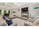 Spacious living room featuring a fireplace, coffered ceilings, and large windows overlooking the backyard at 2585 Drew Valley Ne Rd, Brookhaven, GA 30319
