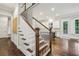 Beautiful wooden staircase with white railings and hardwood floors at 2585 Drew Valley Ne Rd, Brookhaven, GA 30319