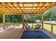 Inviting covered back porch with wood flooring and ample seating area at 3845 Glen Ian Dr, Loganville, GA 30052