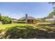 Extensive backyard showcasing manicured lawn, covered porch, and privacy fence at 3845 Glen Ian Dr, Loganville, GA 30052