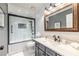 Updated bathroom featuring a tub, framed mirror, and stone countertop at 3845 Glen Ian Dr, Loganville, GA 30052