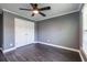 Bedroom with hardwood floors, gray walls, and double door closet at 3845 Glen Ian Dr, Loganville, GA 30052