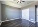 Bedroom with hardwood floors, gray walls, and double door closet at 3845 Glen Ian Dr, Loganville, GA 30052