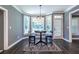 Bright breakfast nook with bay windows, stylish chairs, wood floors, and modern lighting at 3845 Glen Ian Dr, Loganville, GA 30052