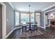 Bright breakfast nook features a modern light fixture, and dark floors and opens to the back patio at 3845 Glen Ian Dr, Loganville, GA 30052