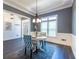 Charming dining room with wainscoting, chandelier, wood floors, and patterned chairs at 3845 Glen Ian Dr, Loganville, GA 30052