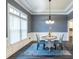 Dining room with wainscoting, chandelier, wood floors, and patterned chairs at 3845 Glen Ian Dr, Loganville, GA 30052