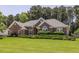 Beautiful brick home featuring lush landscaping, a manicured lawn, and a classic architectural design at 3845 Glen Ian Dr, Loganville, GA 30052