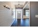 Bright foyer featuring dark hardwood floors, a white wainscotting, and a view into a room at 3845 Glen Ian Dr, Loganville, GA 30052