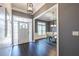 Welcoming foyer showcasing dark hardwood floors, stylish lighting, and an open view to the dining room at 3845 Glen Ian Dr, Loganville, GA 30052