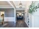 Inviting foyer with dark wood floors and view into the living room, kitchen and dining area at 3845 Glen Ian Dr, Loganville, GA 30052
