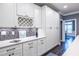 Elegant kitchen with white cabinetry, granite countertops, wine rack, and stylish mosaic backsplash at 3845 Glen Ian Dr, Loganville, GA 30052