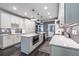 Open kitchen with island, white cabinets, granite countertops, stainless steel appliances, and dark wood floors at 3845 Glen Ian Dr, Loganville, GA 30052