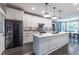 Spacious kitchen with black stainless steel refrigerator, island, granite countertops, and stylish lighting at 3845 Glen Ian Dr, Loganville, GA 30052
